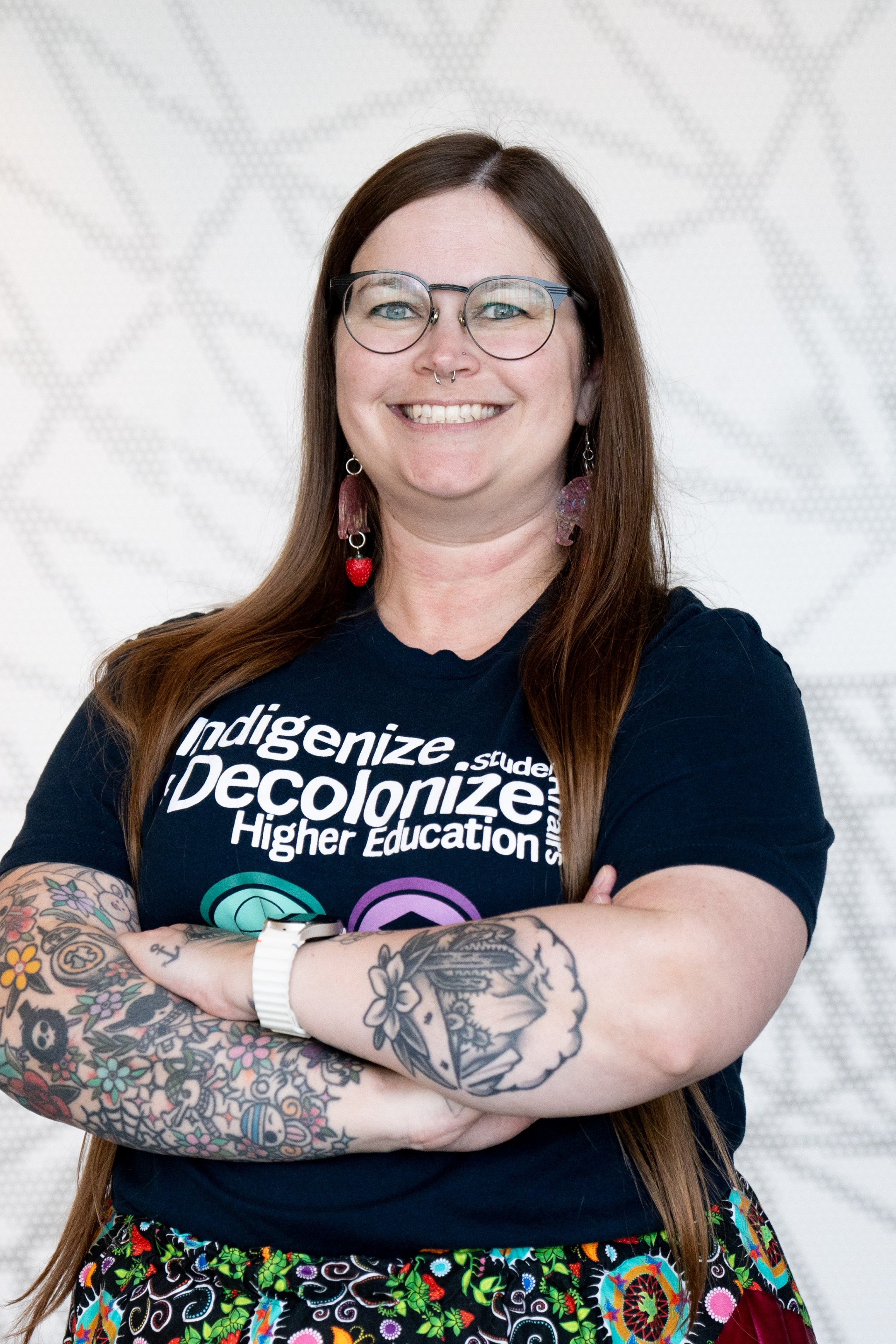 Dr. Shaina Philpot stands with arms crossed and a smile