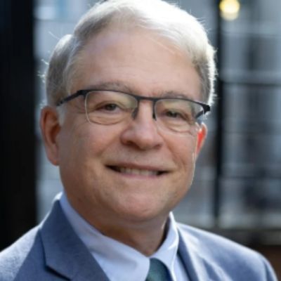 Michael Drexler, a professor in the School of Psychology, smiling under a bright light.